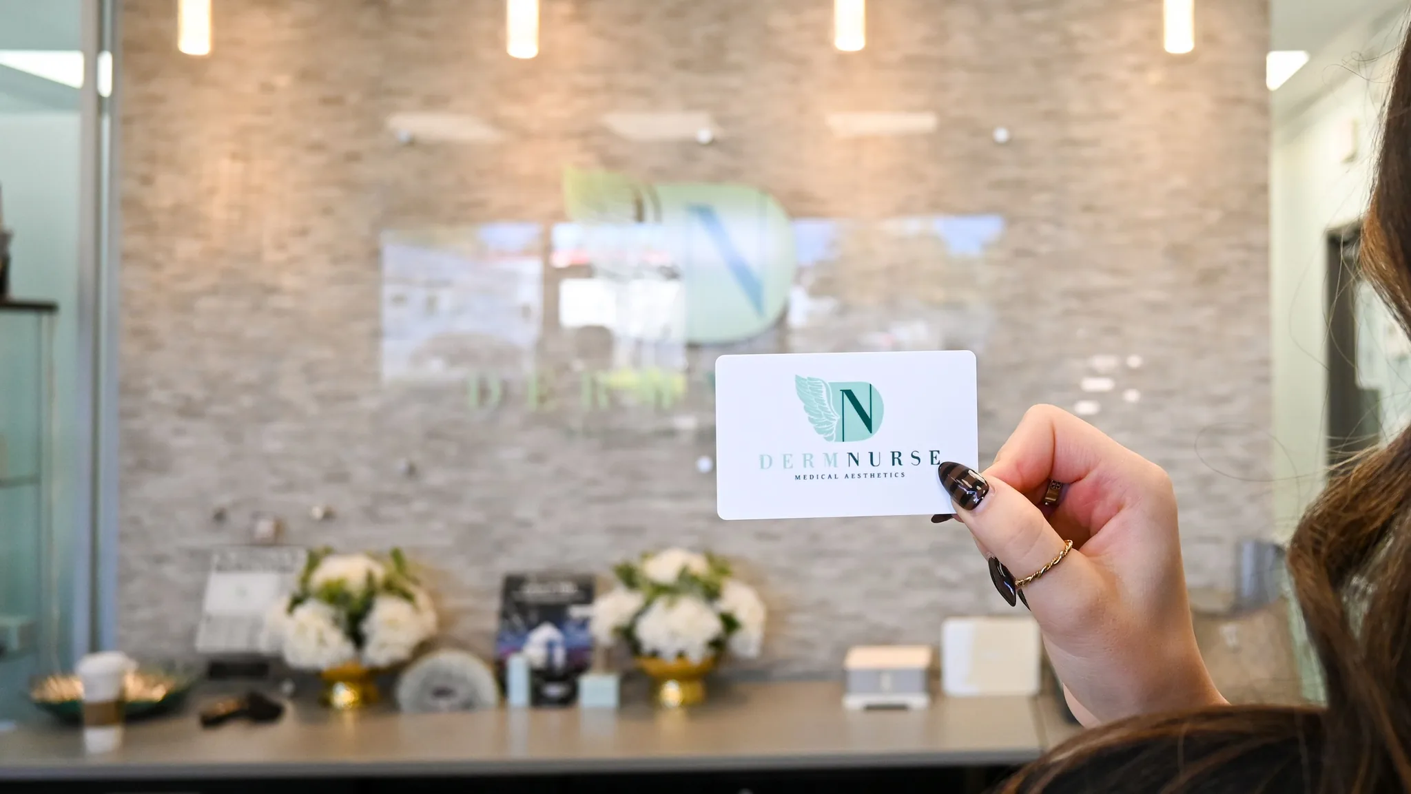 A DermNurse card held up at the clinic’s front desk