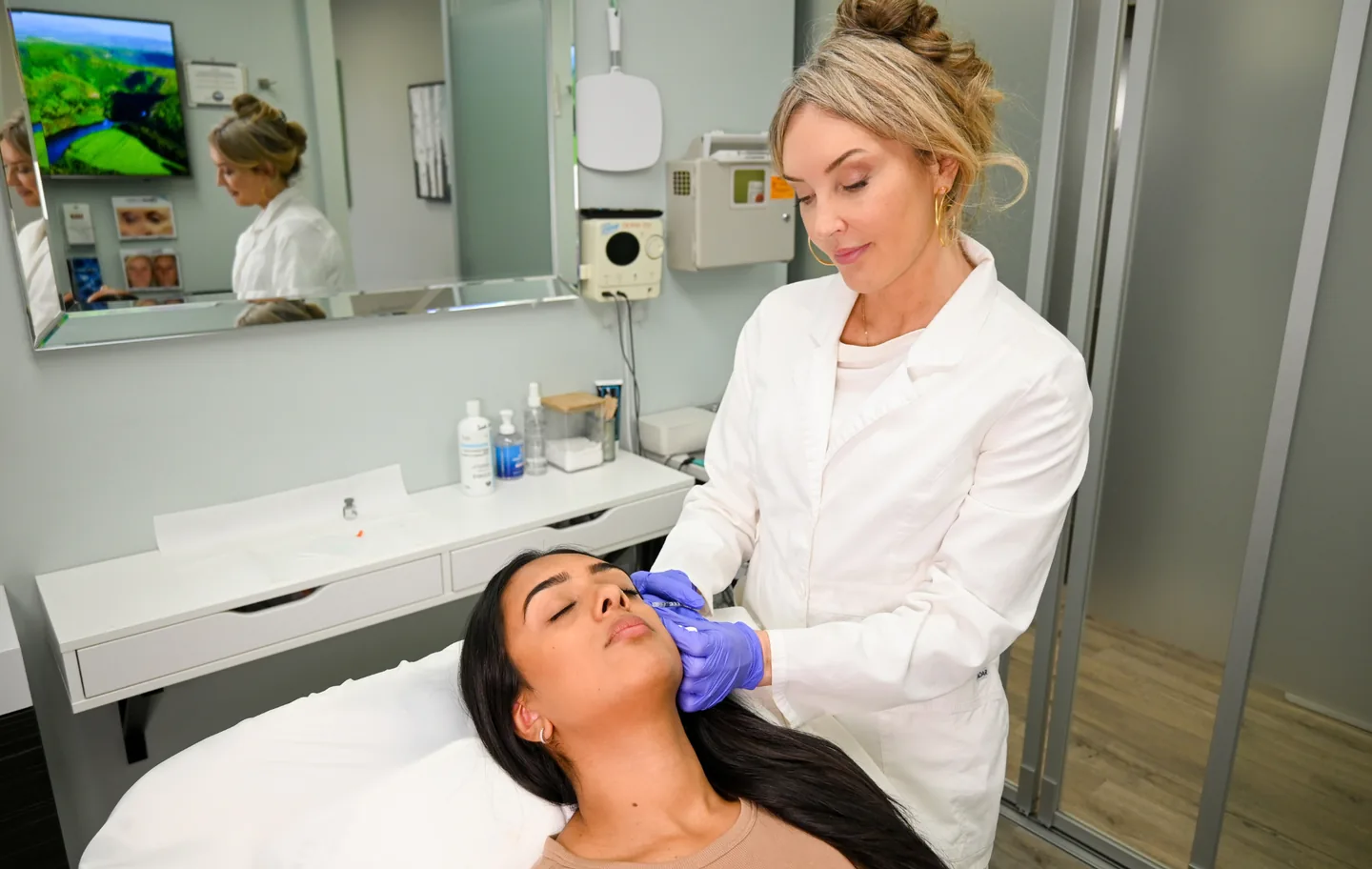 Michelle injecting at a client’s brow in the injection room